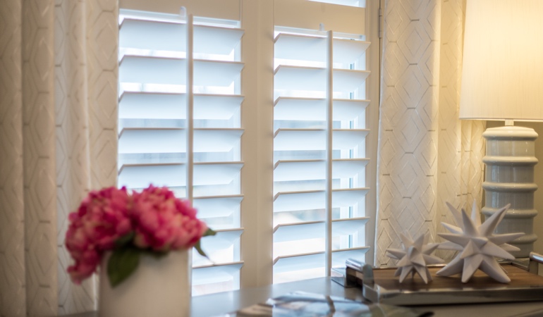 Plantation shutters by flowers in Cleveland
